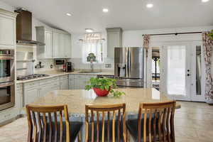 Kitchen with stainless steel appliances, light stone countertops, backsplash, and recessed lighting