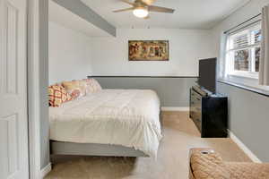 Bedroom featuring light carpet and ceiling fan