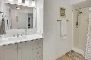 Full bathroom featuring a shower stall and vanity
