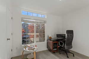 Office space with light wood-style flooring and baseboards
