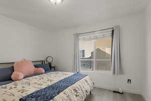 Bedroom featuring baseboards and light wood-type flooring