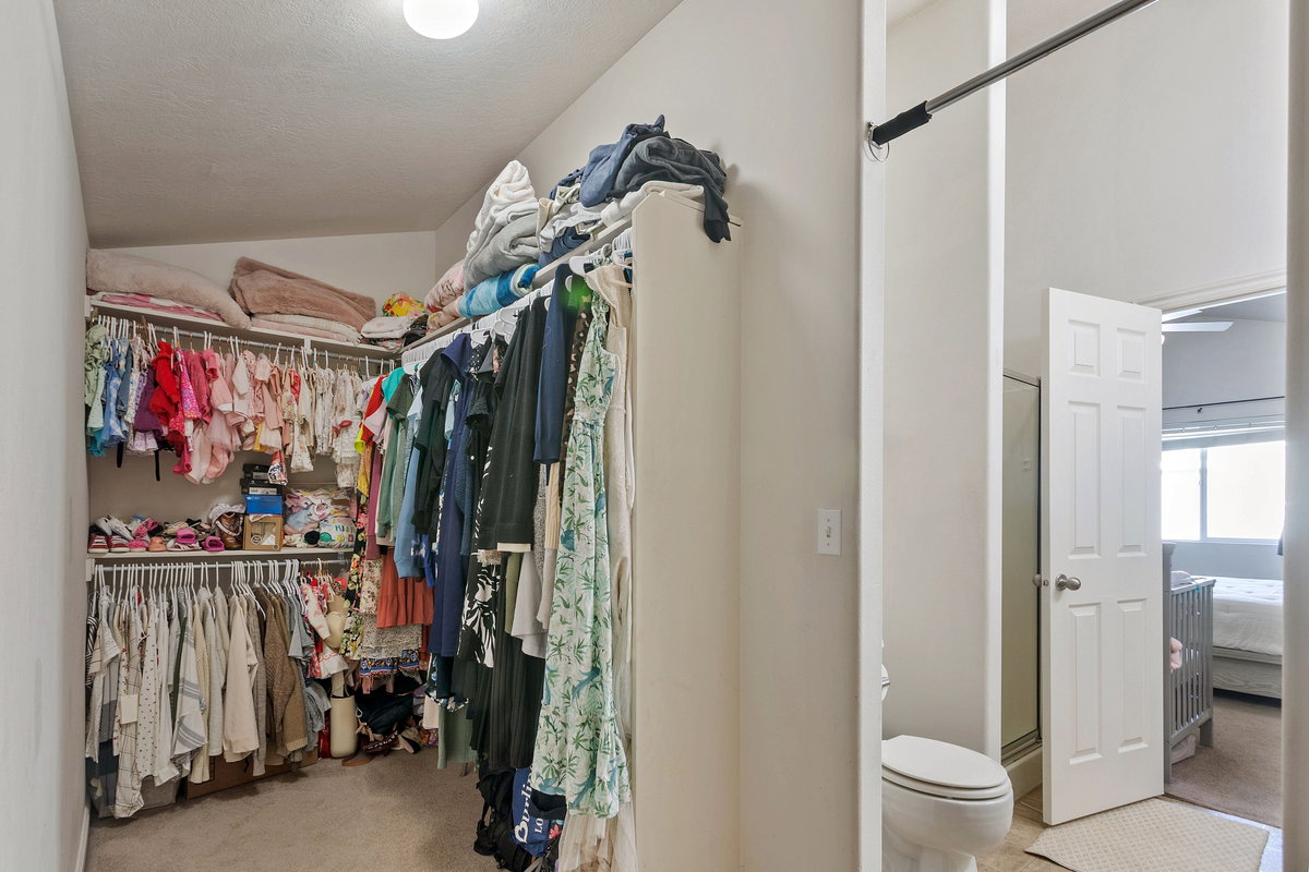 Walk in closet featuring light carpet