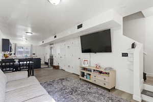 Living area with wood finished floors and baseboards