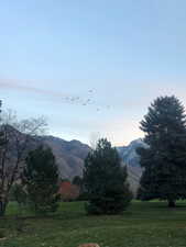 View of mountain backdrop featuring rural landscape
