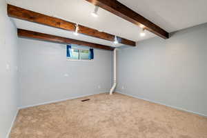 Basement featuring a textured ceiling and carpet