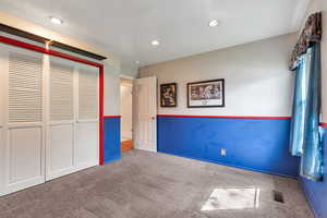 Unfurnished bedroom featuring carpet floors, a closet, and recessed lighting