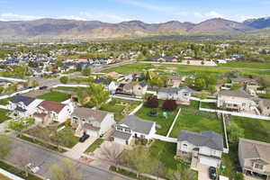 Aerial overview of property's location with a mountainous background and nearby suburban area