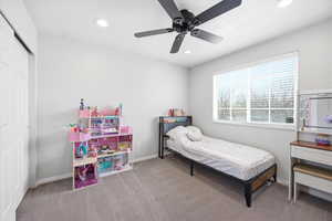 Bedroom featuring ceiling fan, light carpet, recessed lighting, and a closet