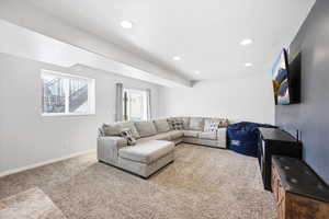Living area featuring carpet, recessed lighting, and a textured ceiling