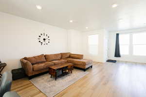 Living room featuring light wood-style floors and recessed lighting
