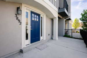 Entrance to property featuring stucco siding