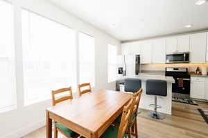 Dining room featuring light wood-style floors and recessed lighting
