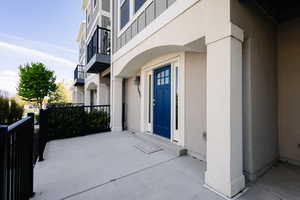 Entrance to property featuring stucco siding