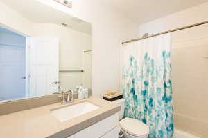 Full bathroom with vanity and shower / bath combo with shower curtain