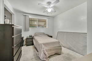 Bedroom featuring light carpet and ceiling fan