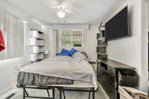 Carpeted bedroom with ceiling fan