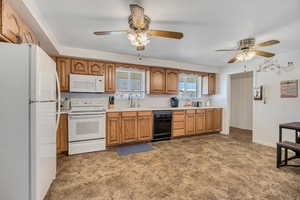 Kitchen with white appliances, light countertops, and wood finish cabinetry