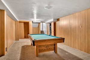 Rec room with wooden walls, carpet floors, and billiards table