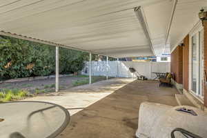 Fenced backyard with a patio area