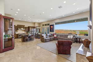 Living area featuring suspended lighting