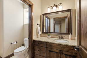 Half bathroom with toilet and vanity