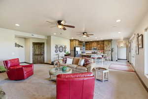 Living area featuring recessed lighting, ceiling fan, and light carpet
