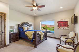 Bedroom with light colored carpet, ceiling fan, and recessed lighting