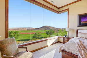 Carpeted bedroom featuring a mountain view, crown molding, and view of golf course