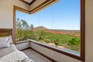 Sunroom / solarium featuring a mountain view and view of golf course