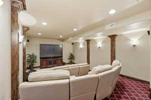 Cinema room with recessed lighting and decorative columns