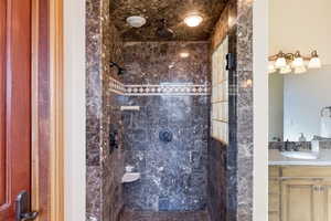 Bathroom featuring a stall shower and vanity