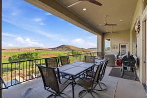 View of patio featuring a ceiling fan, a mountain view, a grill, and outdoor dining space
