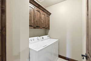 Laundry room with cabinet space and washer and dryer