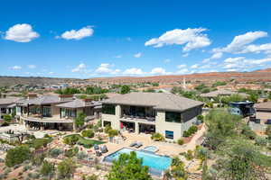 Aerial view of residential area featuring a pool and a mountainous background