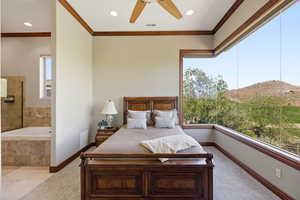 Bedroom with a mountain view, crown molding, ceiling fan, recessed lighting, and ensuite bathroom