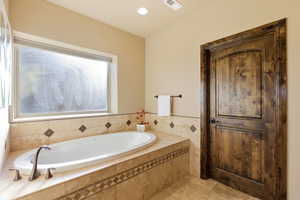 Full bathroom with a bath and recessed lighting