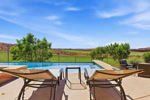 View of pool with a fenced backyard and patio surround