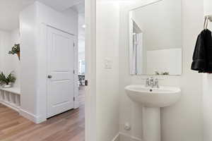 Bathroom featuring light wood-style flooring and baseboards
