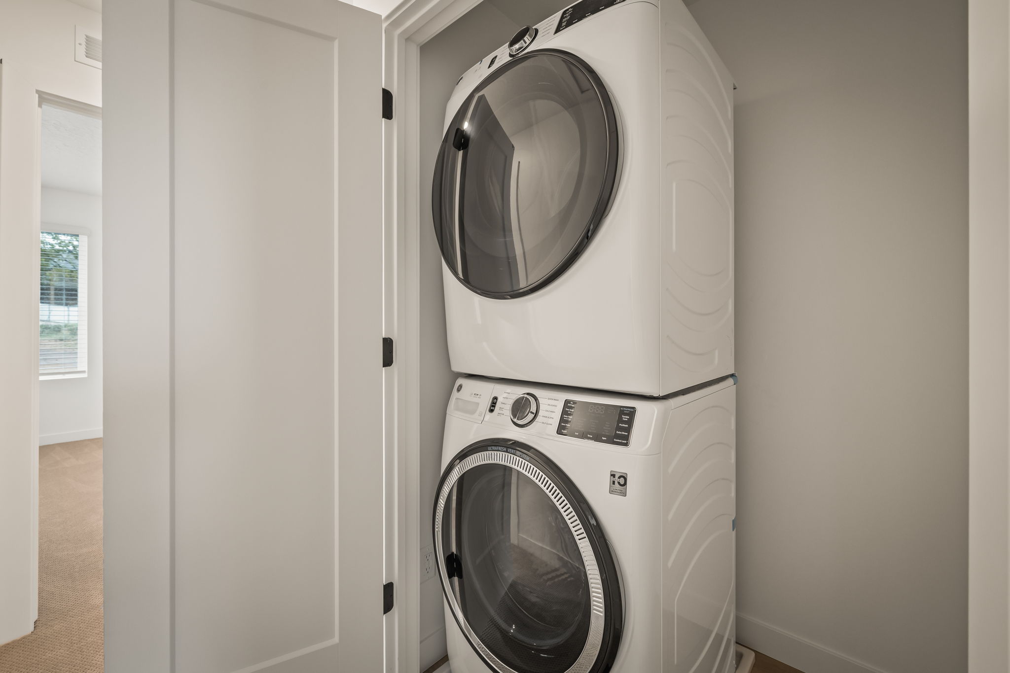 White stacked washer and dryer unit