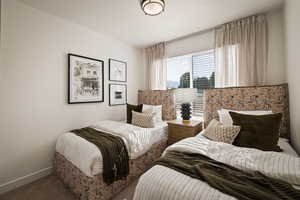 Carpeted bedroom featuring baseboards