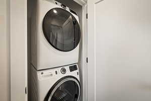 Laundry area featuring stacked washer / drying machine
