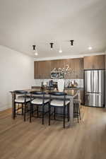 Kitchen with stainless steel appliances, light wood-type flooring, wood finish cabinetry, and modern cabinets