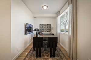 Dining space featuring light wood-style flooring and a desk