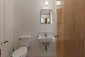 Bathroom featuring toilet and baseboards