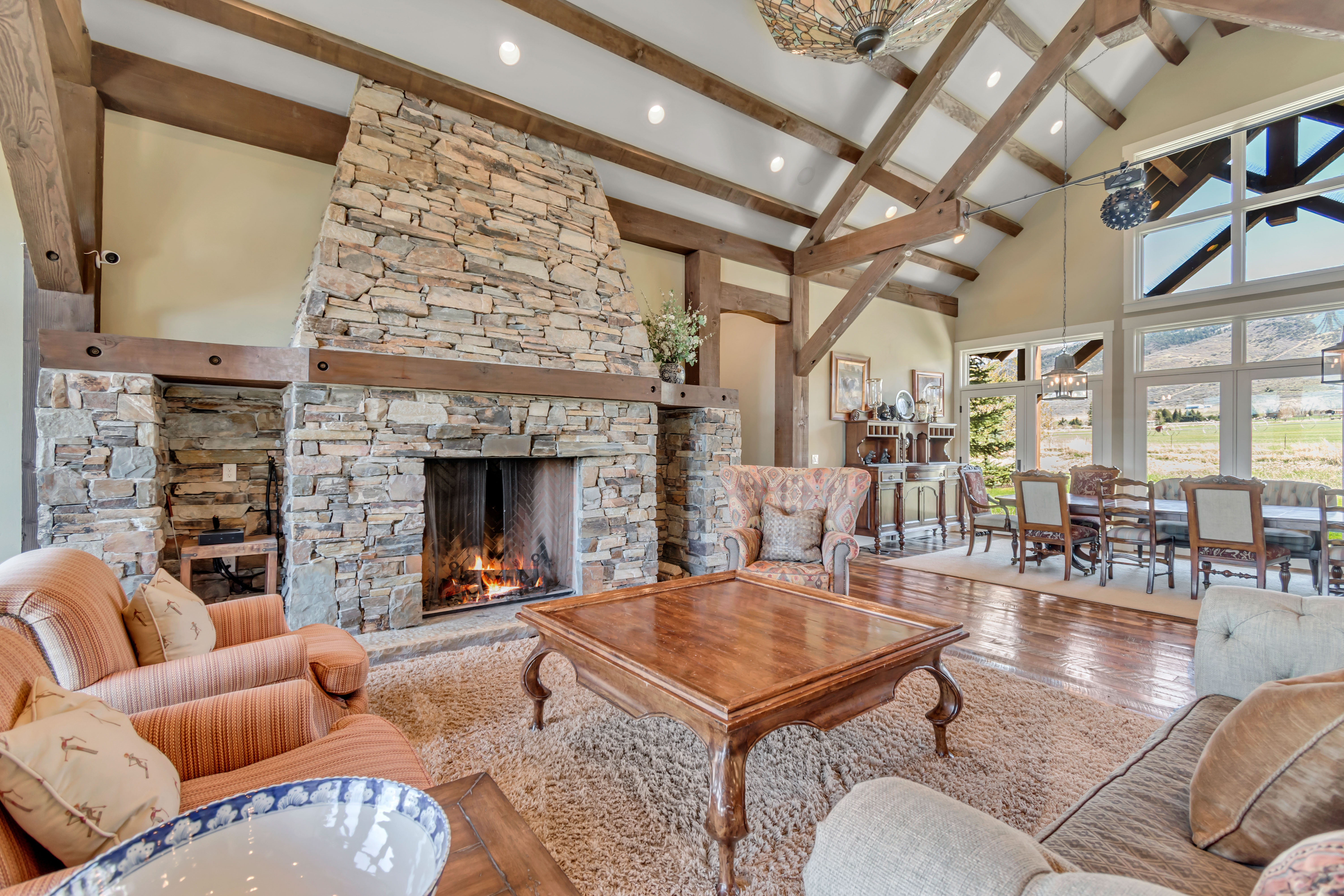 Living room featuring hardwood / wood-style floors, a fireplace, vaulted ceiling, and recessed lighting