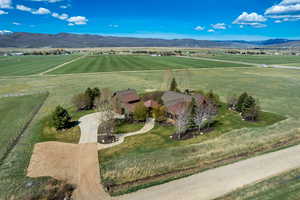 Aerial view of sparsely populated area featuring agricultural land and a mountainous background