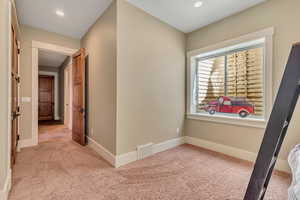 Corridor featuring light carpet and recessed lighting