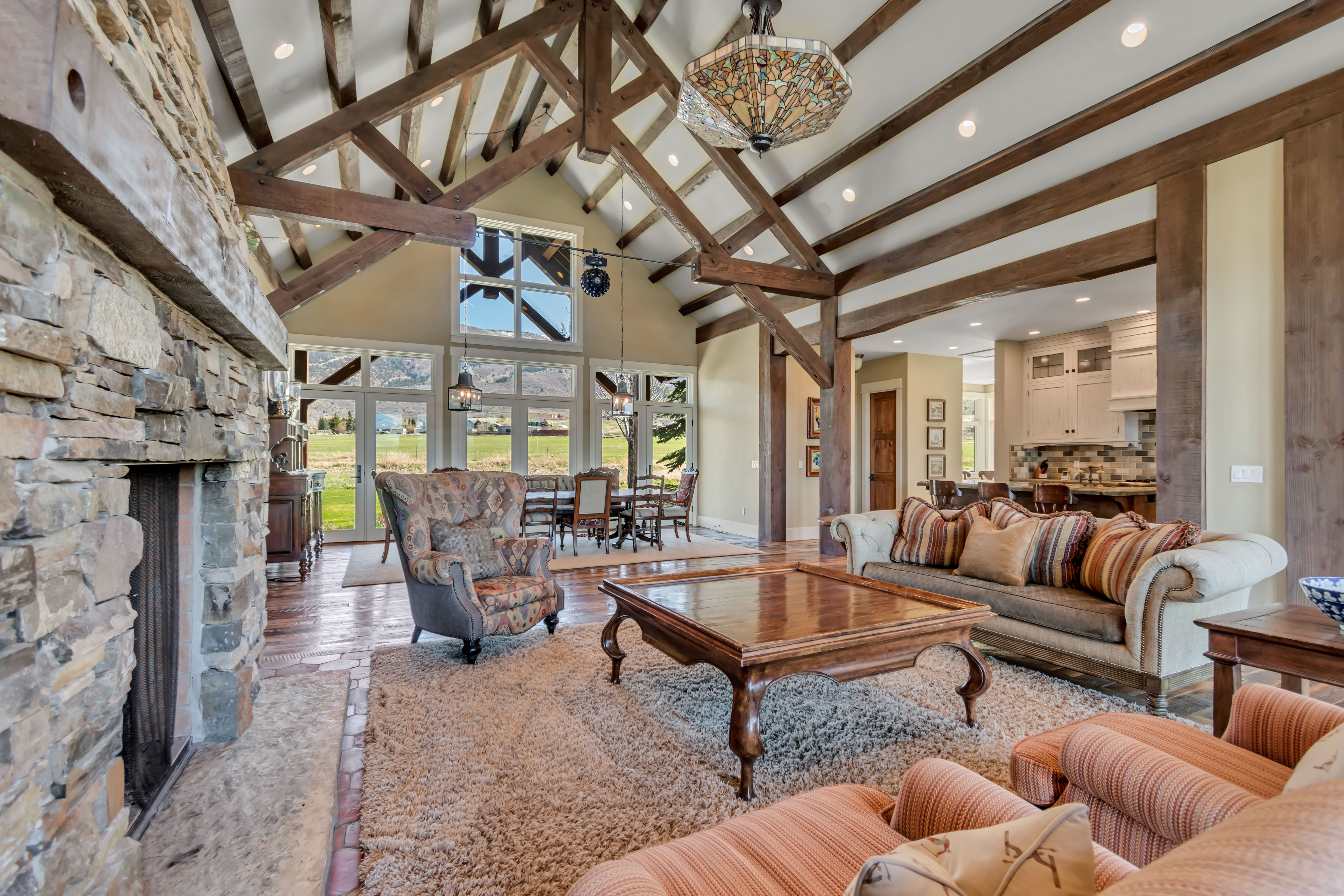 Living area featuring a fireplace, vaulted ceiling, recessed lighting, and wood finished floors