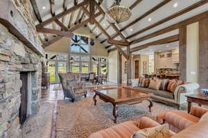 Living area featuring a fireplace, vaulted ceiling, recessed lighting, and wood finished floors