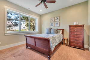Bedroom with ceiling fan, light colored carpet, and recessed lighting